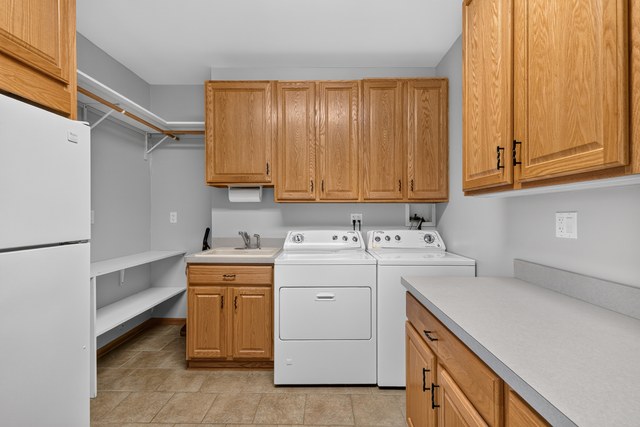 Laundry room with utility sink and storage