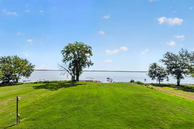 Level lawn running down to the water