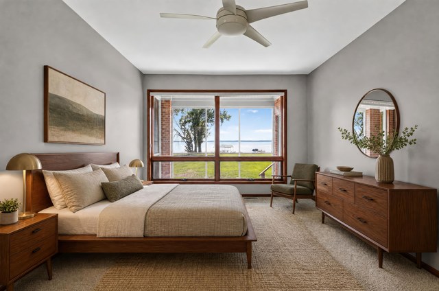 Primary bedroom with lake view (virtually staged)